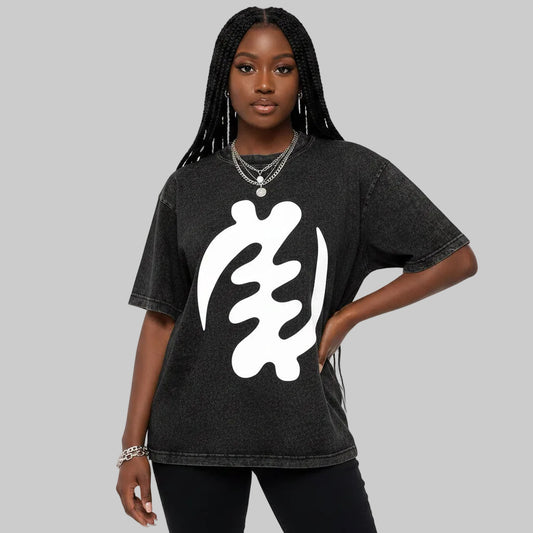 Person wearing a black t-shirt with a white abstract design on a plain background