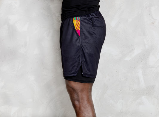 Person wearing a black athletic outfit with kente logos on a white background. comes with a compression shorts