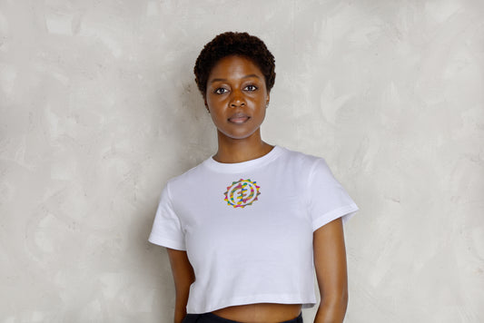 Person wearing a white t-shirt with a colorful circular design against a plain background
Black woman wearing white leggings with colorful kente designs on a plain background. Athletic wear. Gym outfit,