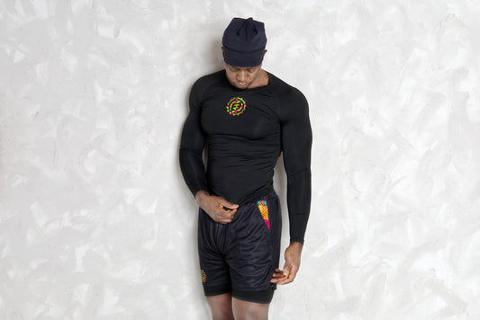 Person wearing a black athletic outfit with kente  logos on a white background. comes with a compression shorts 