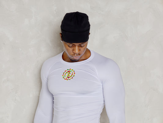 Person wearing a white long-sleeve shirt with a colorful logo on a plain background
Black Man wearing active long sleeve kente shirt and white shorts with compression 