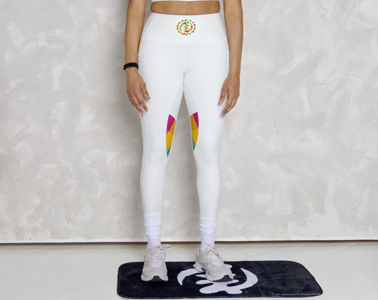 Black woman wearing white leggings with colorful kente designs on a plain background. Athletic wear. Gym outfit, 